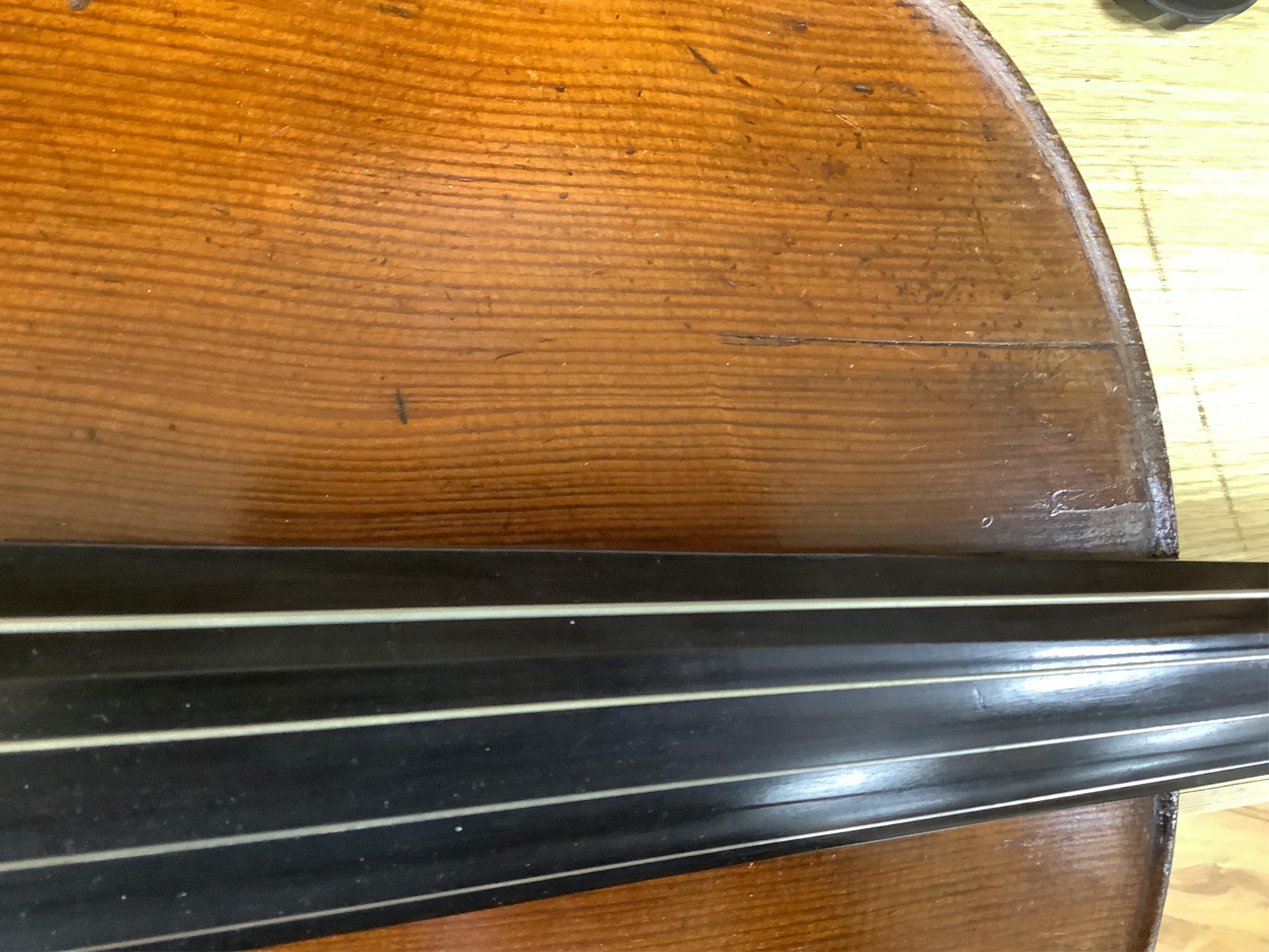 A cased late 19th century German? cello, body length 75cm, together with two bows. Condition - fair to good.